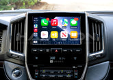 Car dashboard with a touchscreen display showing various app icons.
