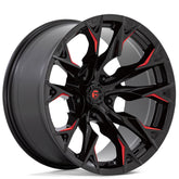 Black alloy wheel with red milled accents on a white background