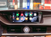 Car dashboard with a touchscreen display showing app icons.