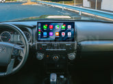 Car dashboard with a touchscreen display showing various app icons.