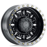 Close-up of a black and silver rim with gold accents on a white background