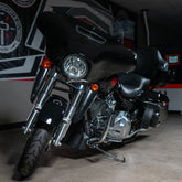 Black motorcycle parked indoors with a blurred background