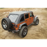 Orange off-road vehicle with a gray soft top on a sandy terrain