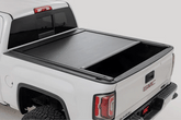 GMC truck bed with a tonneau cover on a white background