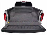 Truck bed with a black cargo bed liner on a white background