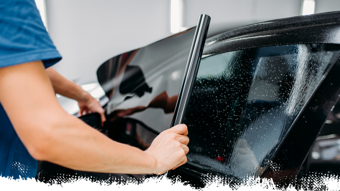 Images of someone applying tint on the car.  