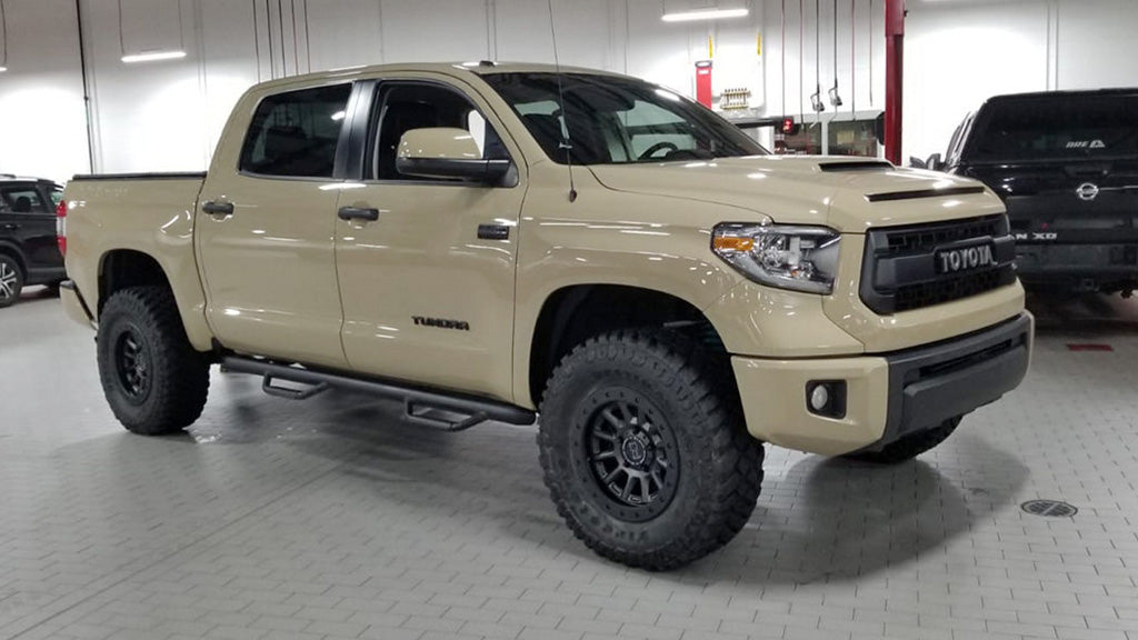 Beige Toyota truck with custom wheels 