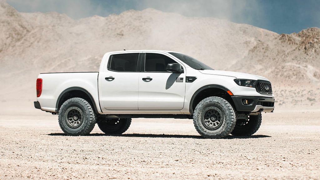 White pickup truck with custom wheels