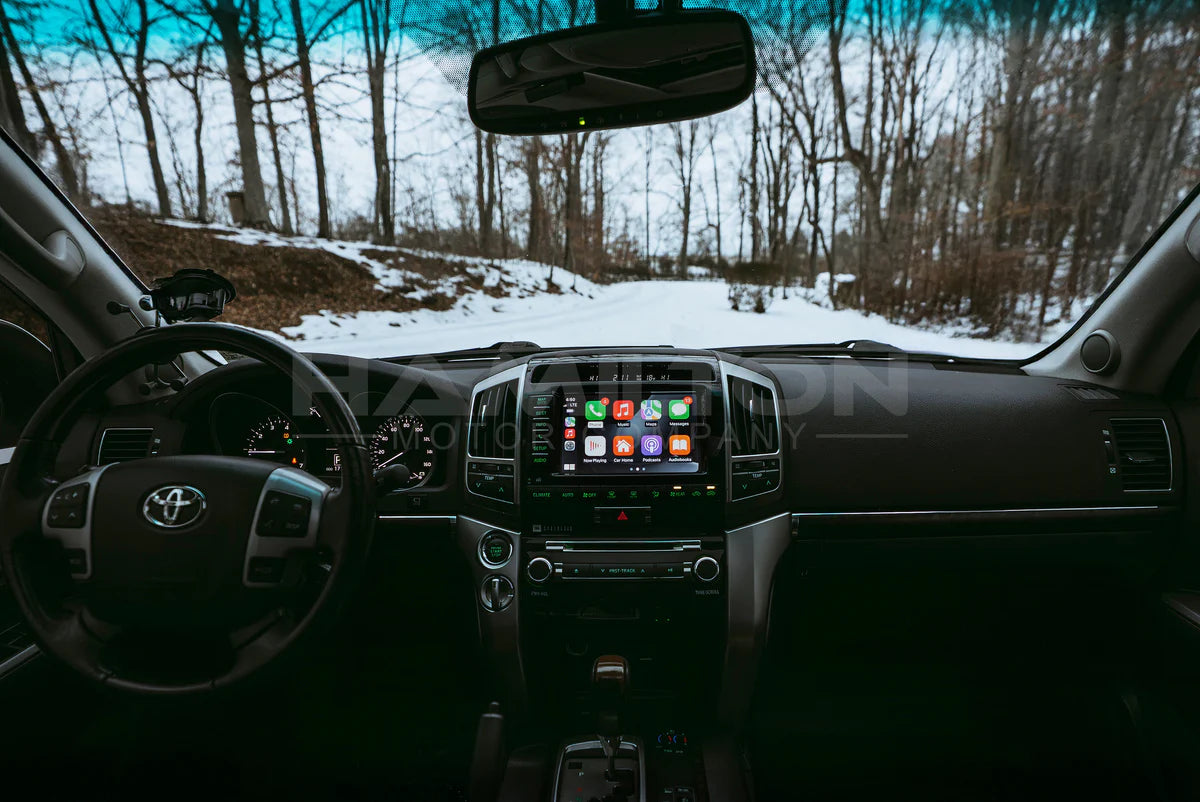 Car interior with a focus on the dashboard and steering wheel, showing a snowy landscape outside.