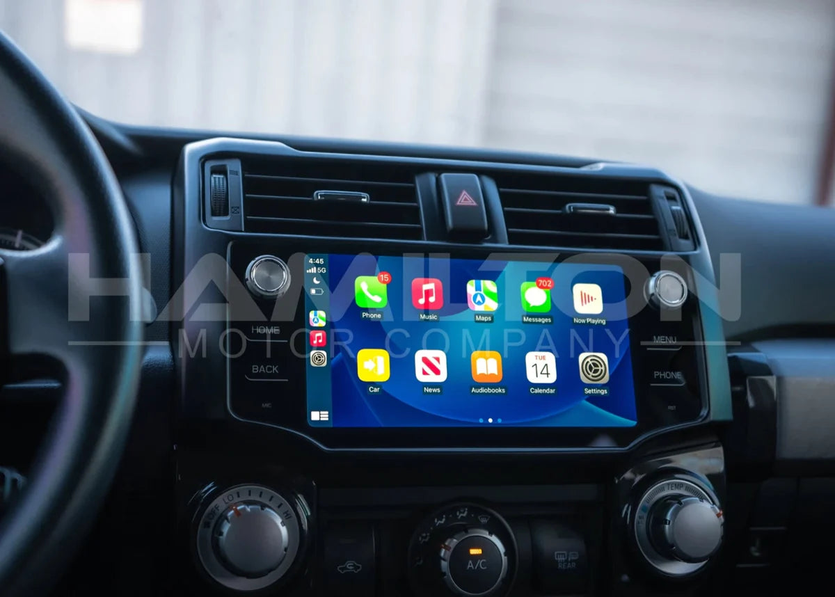 The car dashboard features a touchscreen display that displays app icons.