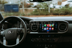 Car interior with dashboard and steering wheel, showing a smartphone app interface.