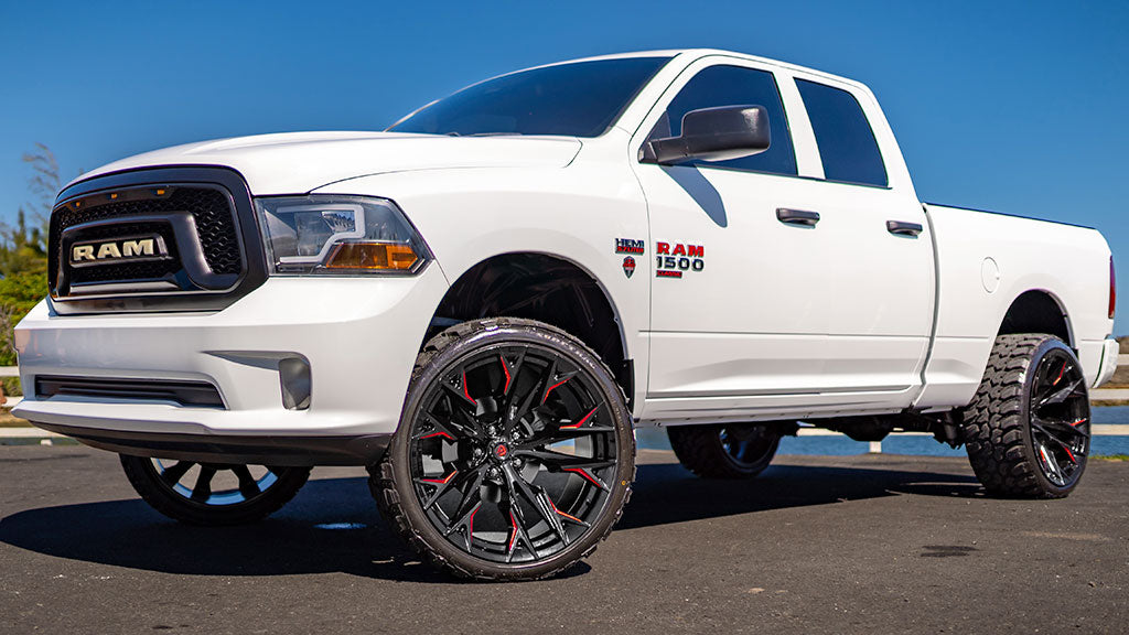 White Ram truck with large black wheels on a clear day