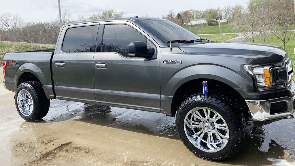 The image showcases a 22-inch Hardrock H503 Spine Xposed on a Ford F-150 truck.