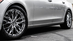 The image captures a close-up of a car's shiny Lexani 22" wheels 