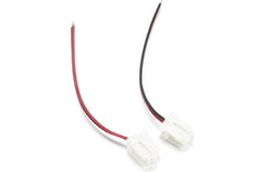 Two white connectors with red and black wires on a white background