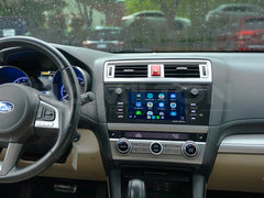 Car interior with dashboard, steering wheel, and touchscreen display.