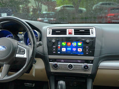 Car interior with a focus on the dashboard and steering wheel, showing the infotainment system.