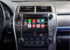 Car dashboard with a touchscreen infotainment system displaying various icons.