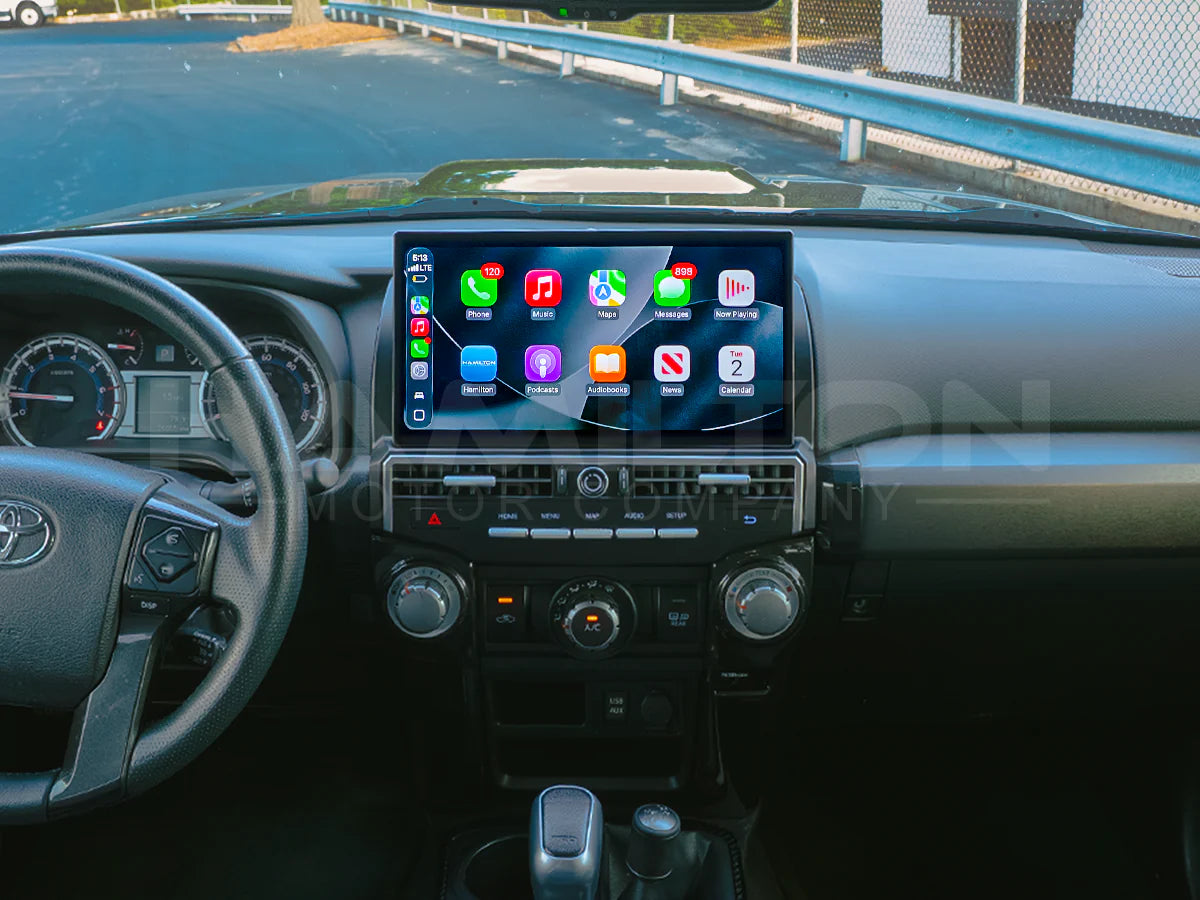 Car dashboard with a touchscreen display showing various app icons.