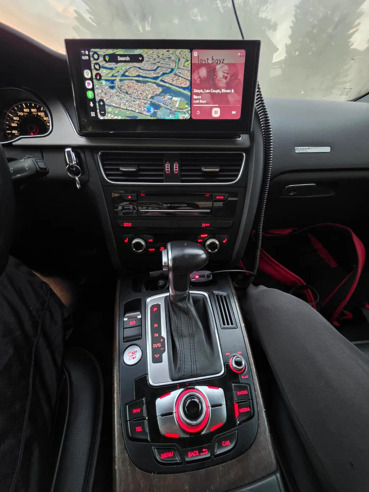Car interior with a focus on the dashboard, including a navigation screen and gear shift.