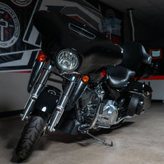 Black motorcycle parked indoors with a blurred background
