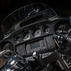 Close-up of a motorcycle dashboard with controls and display.