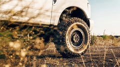 Off-road vehicle with large tire on a dirt road