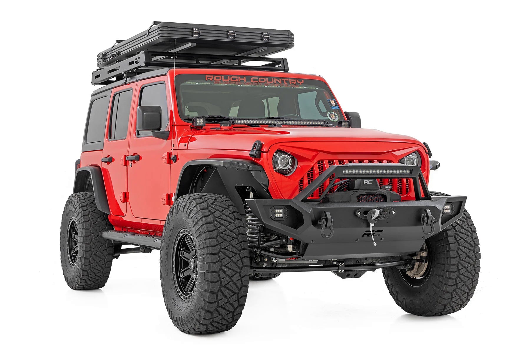 Red off-road vehicle with roof rack and additional lights on a white background