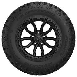 Black tire with a detailed tread pattern on a white background