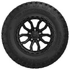 Black tire with a detailed tread pattern on a white background