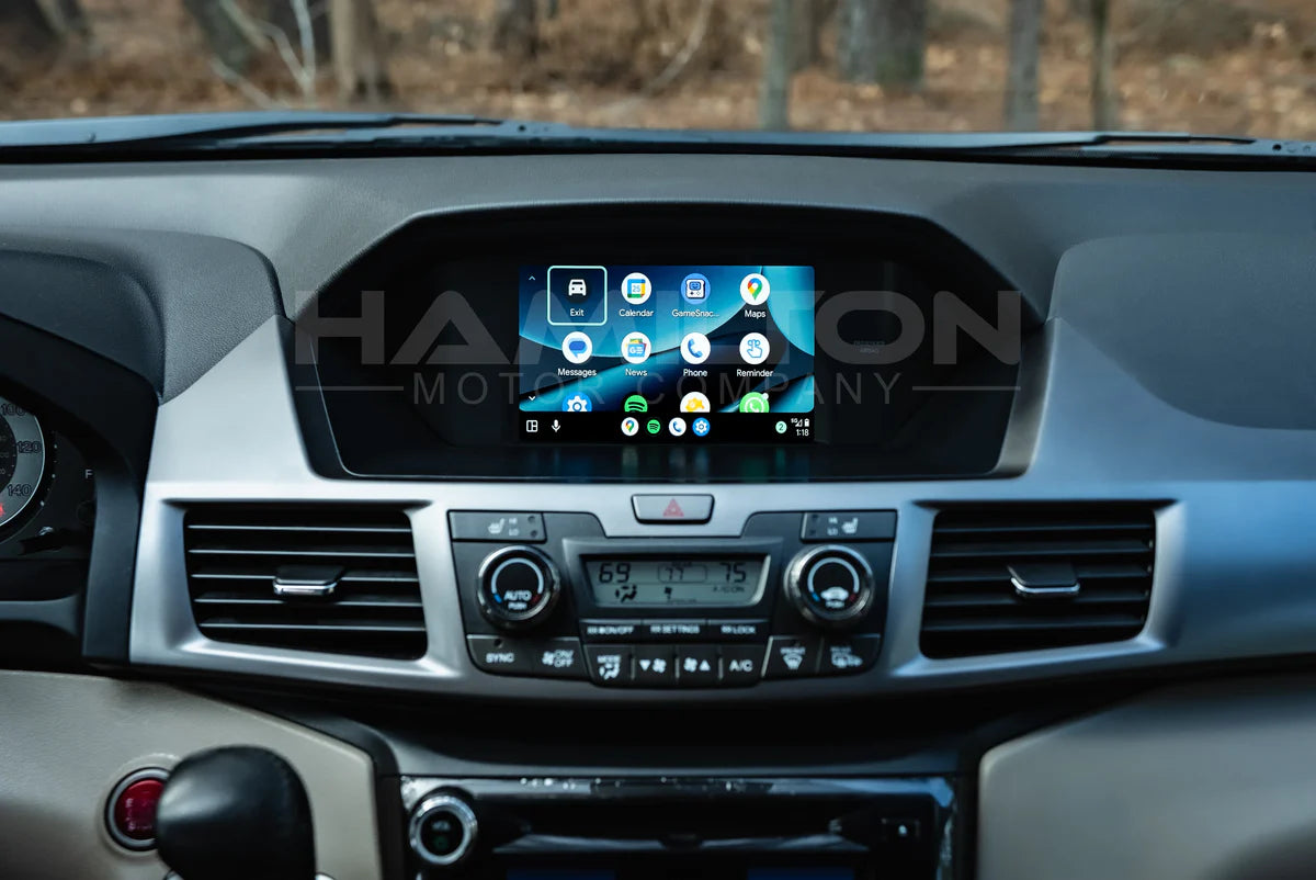 Car dashboard with a touchscreen display and air conditioning vents.
