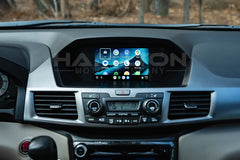 Car dashboard with a touchscreen display and air conditioning vents.