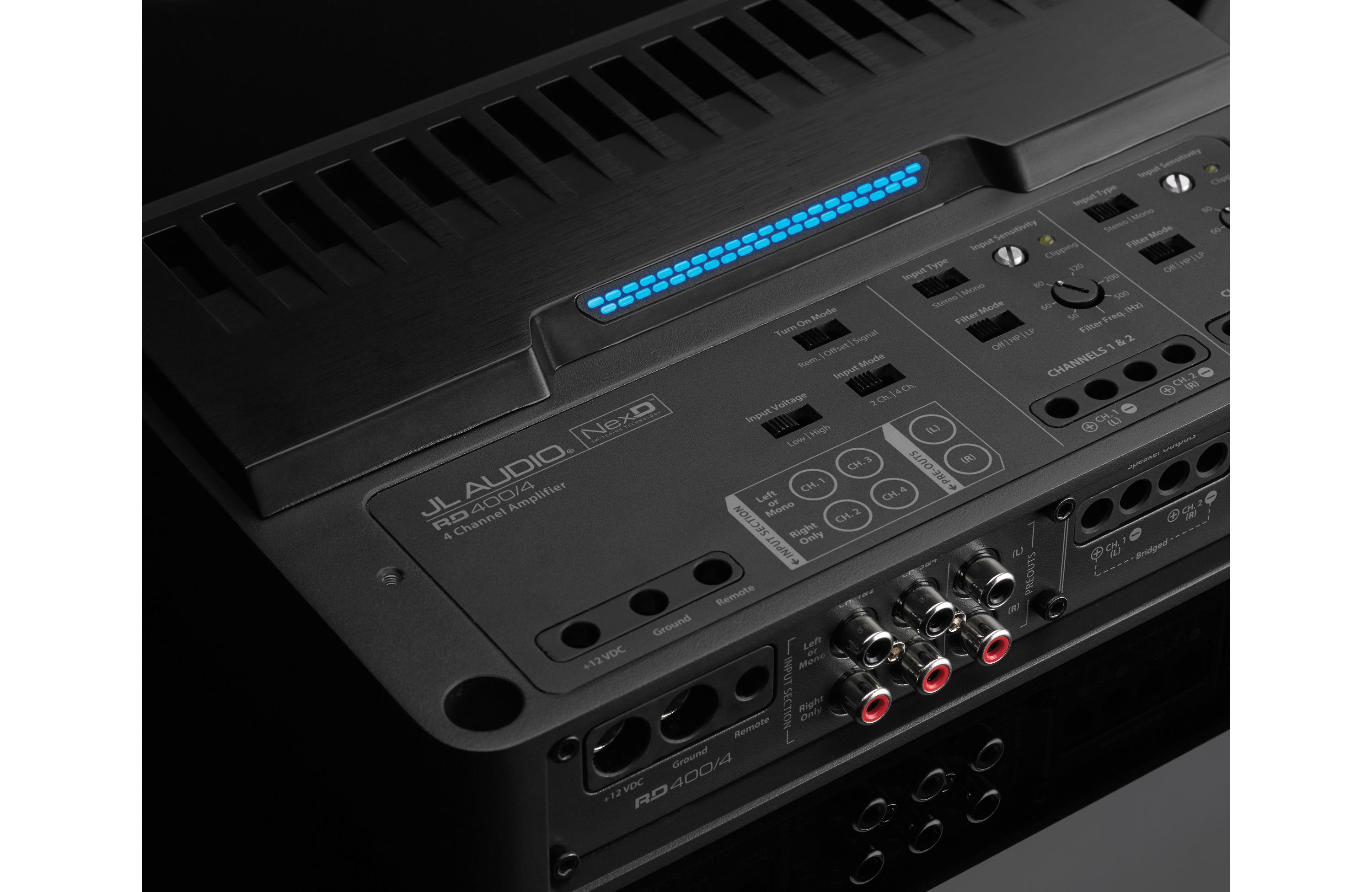 Close-up of a JL Audio amplifier with control panel and branding.
