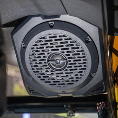 Close-up of a speaker with a grid pattern on a blurred background