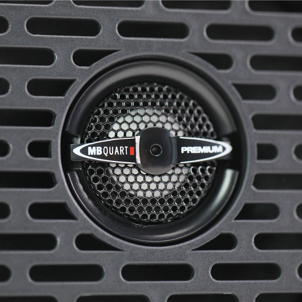 MB Quart speaker with honeycomb pattern on a black grille