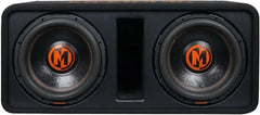A black dual-subwoofer car audio enclosure with two large woofers and orange circular 'M' logos on the driver centers, shown against a plain white background.
