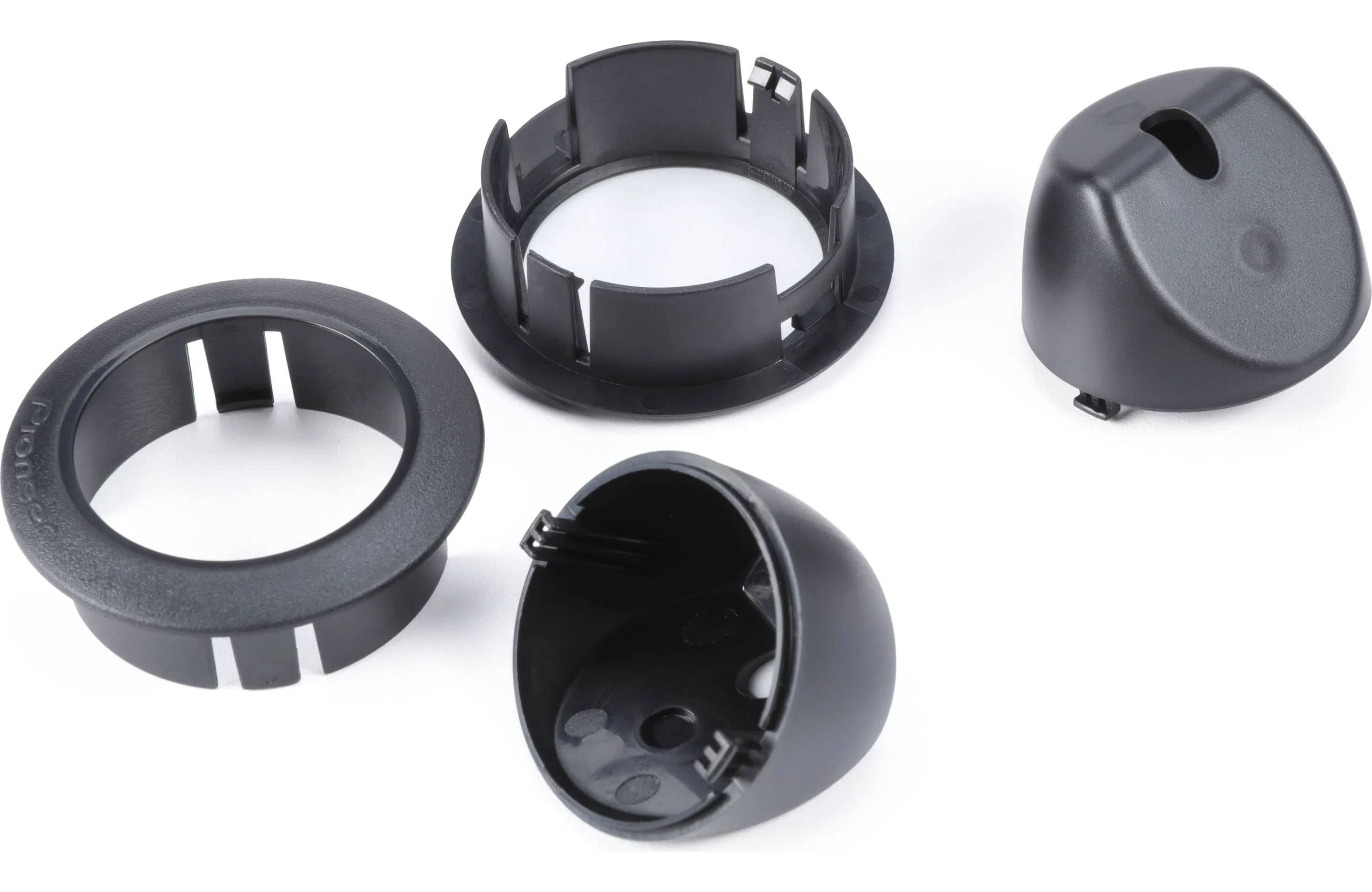 Four black plastic components on a white background