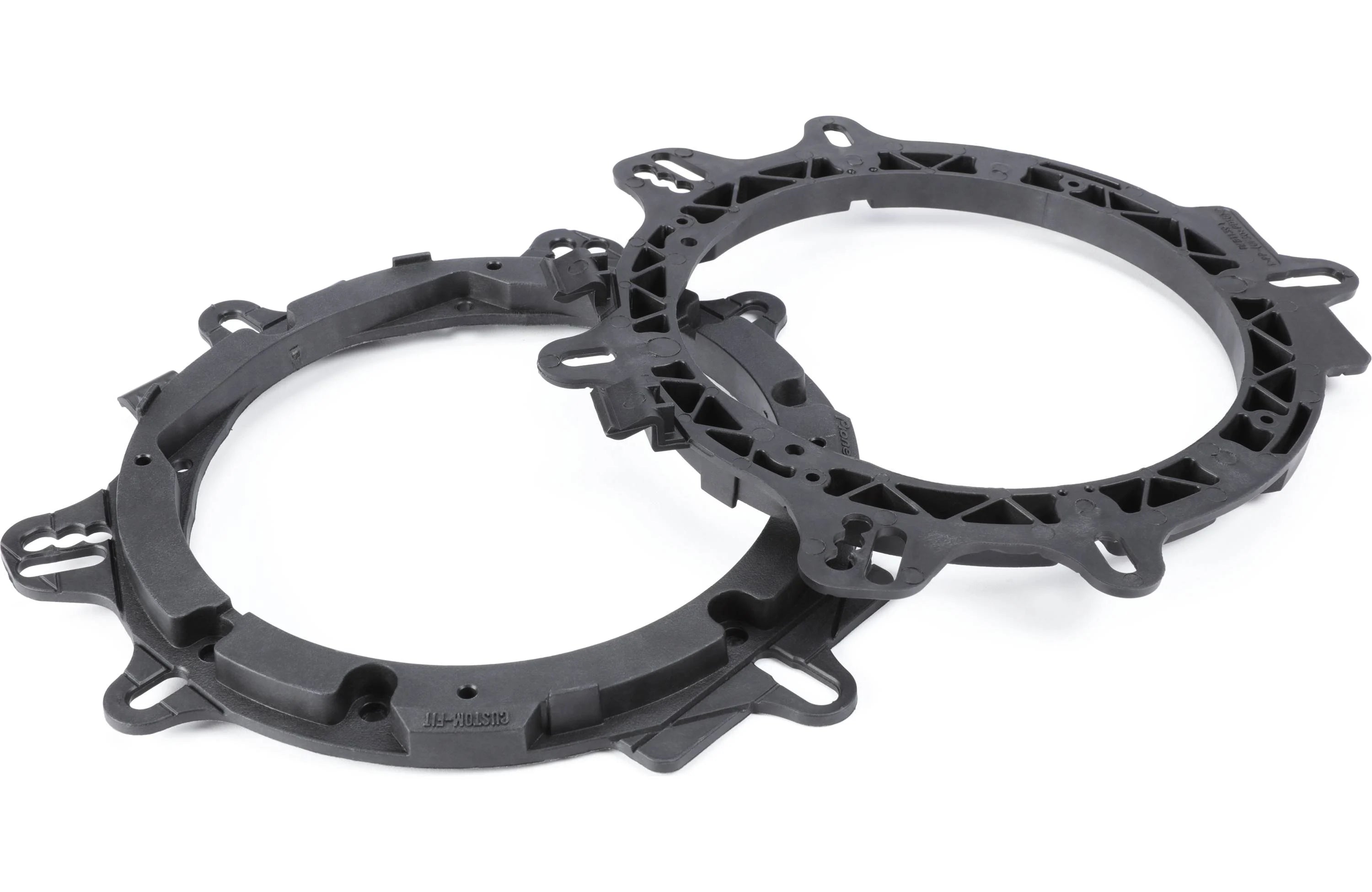 Two black plastic ring components on a white background