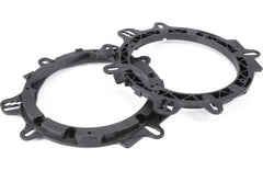 Two black plastic ring components on a white background