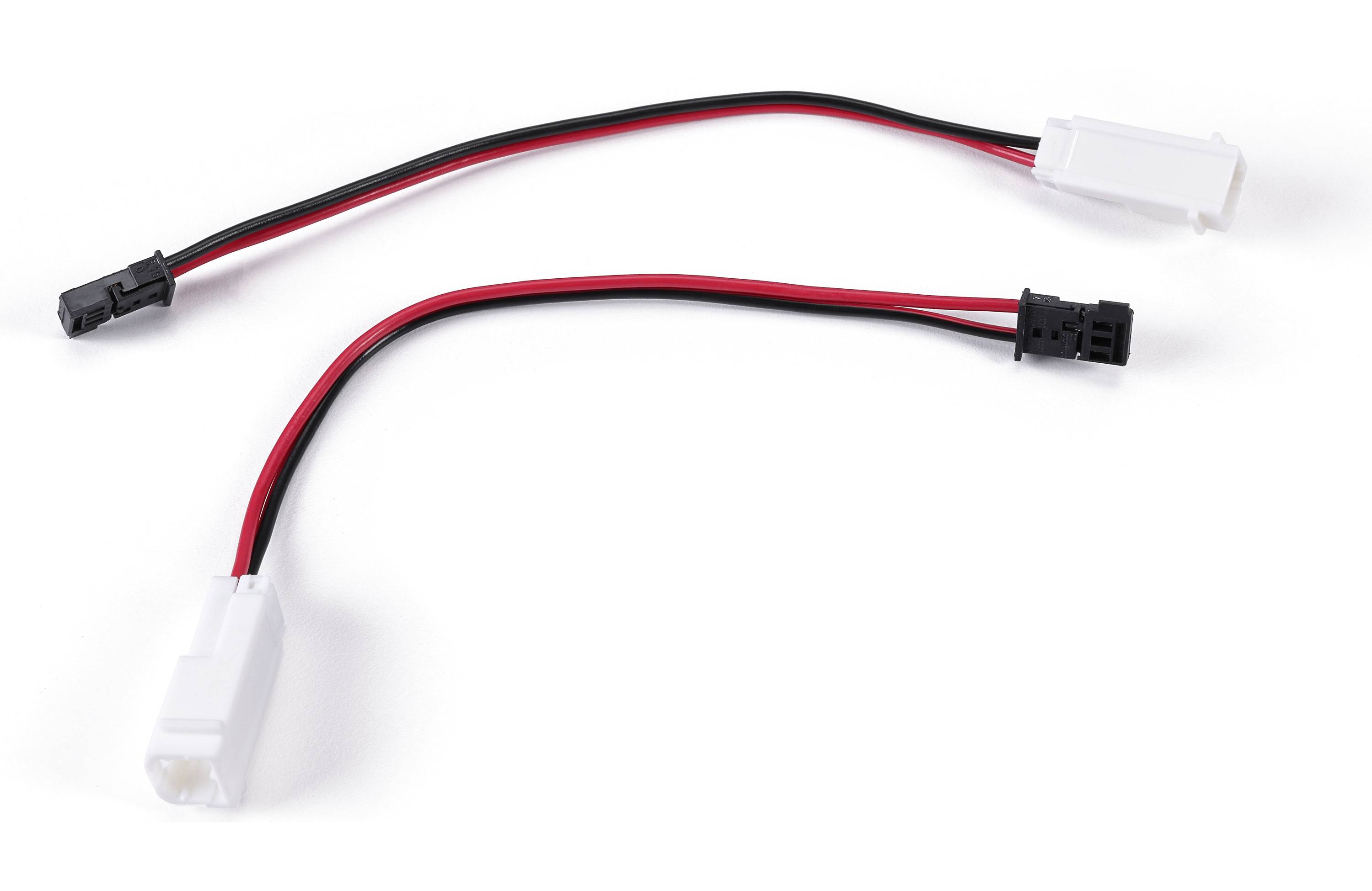 Two small electrical connectors with red and black wires on a white background