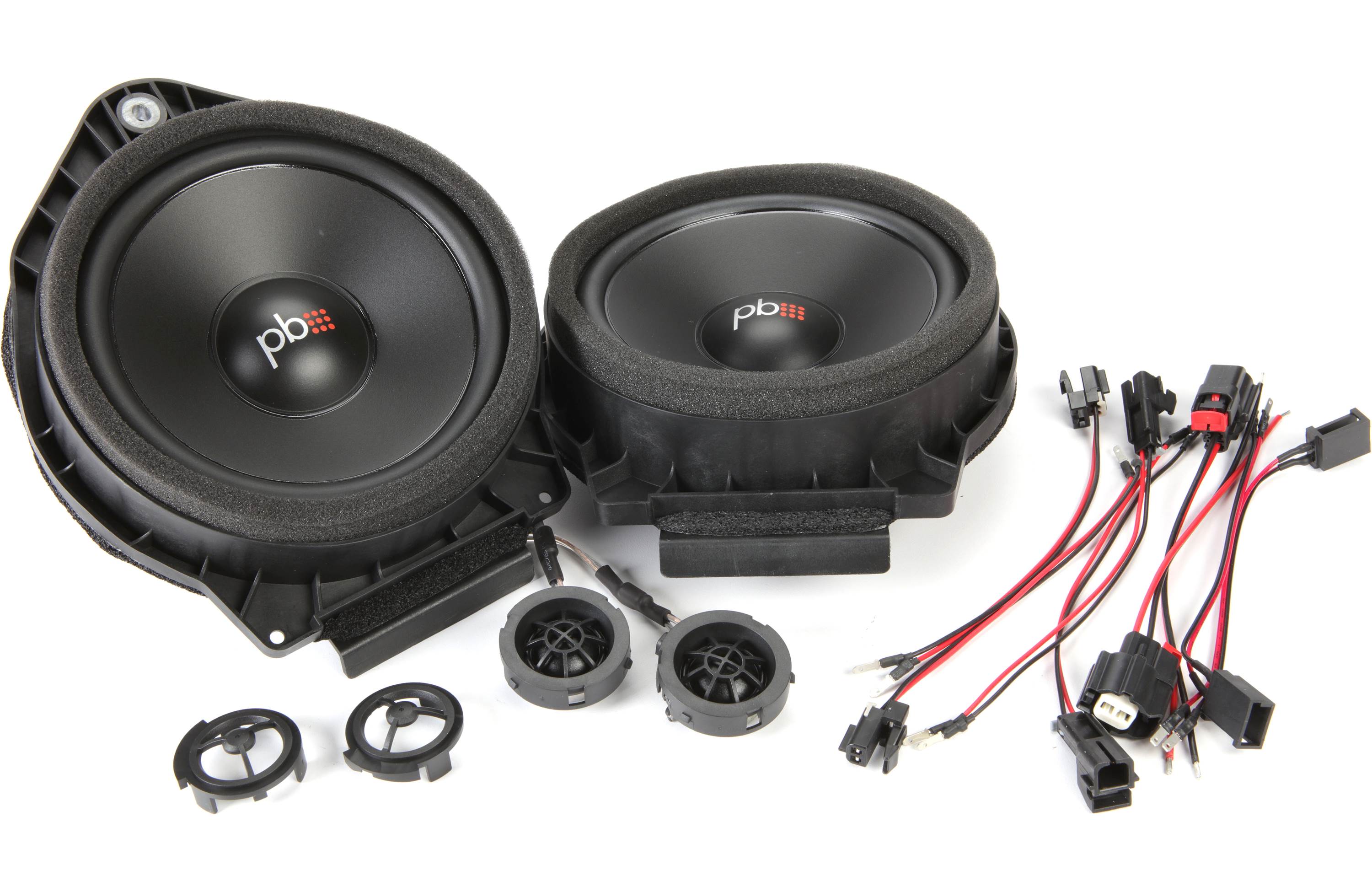 Pair of car speakers with wiring harness on a white background