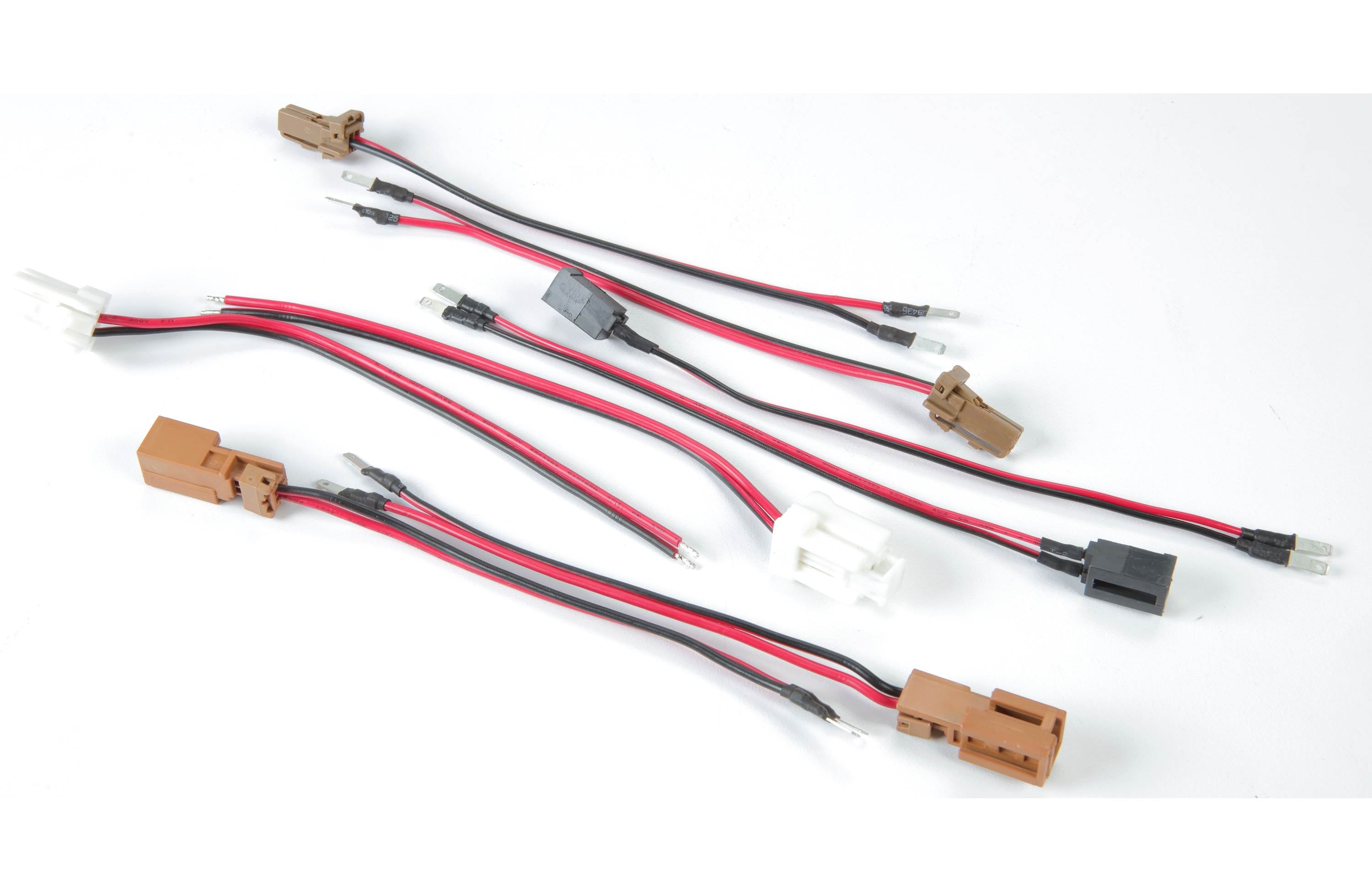 Set of electronic connectors with red and black wires on a white background
