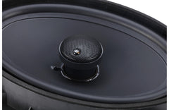 Black car speaker with grille on a black background