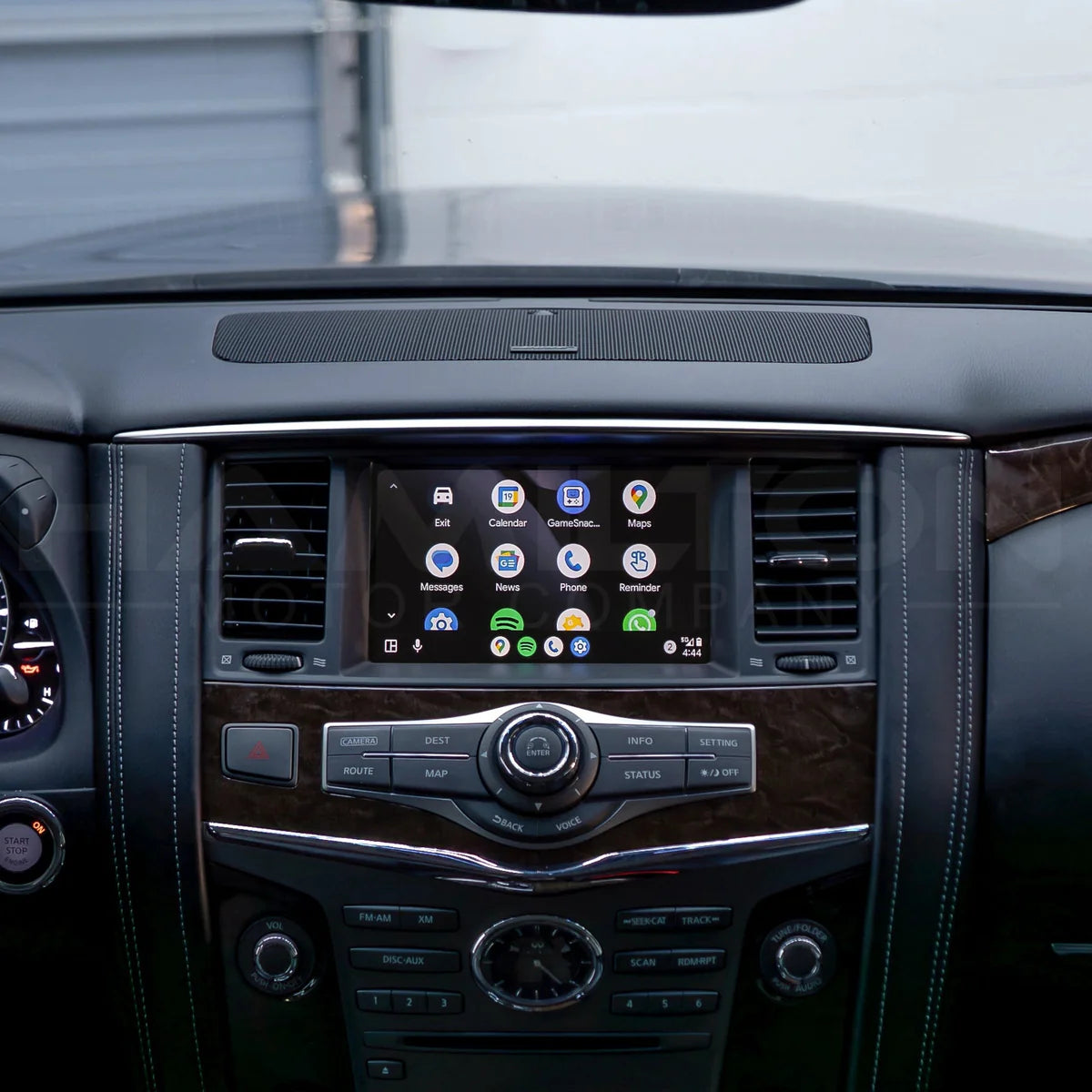 Car dashboard with a touchscreen display and control buttons.