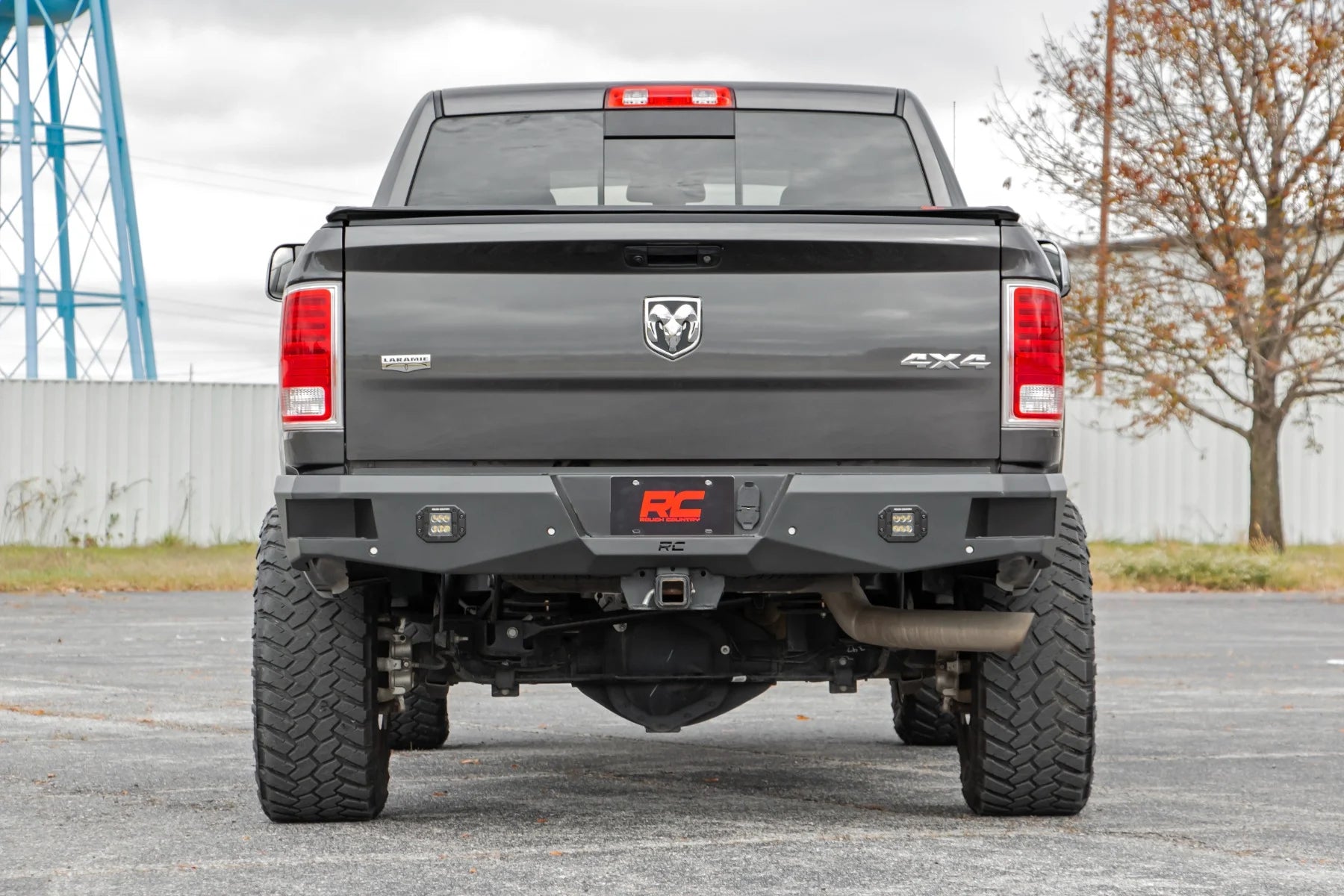 Back view of a black Ram truck with '4x4' with rough country rear bumper.