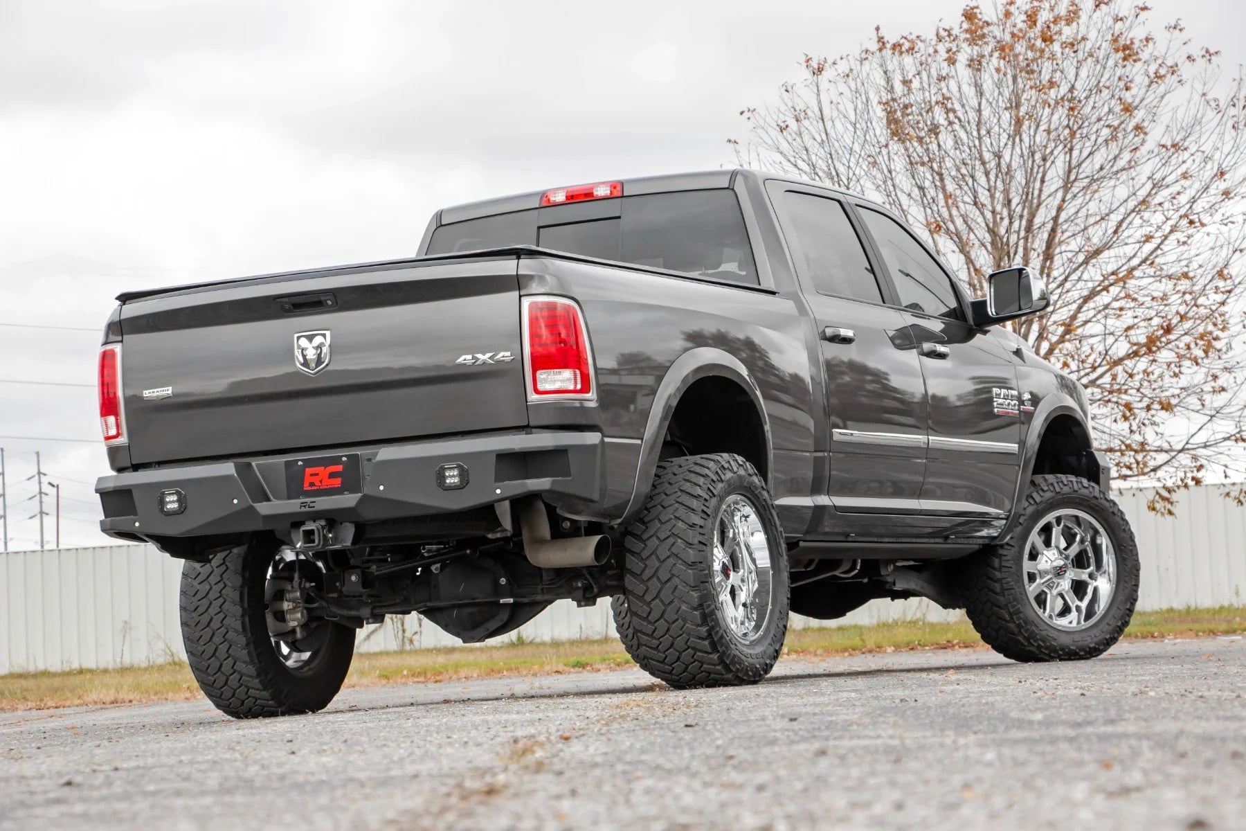 Gray pickup truck with lifted suspension on a road and rear bumper