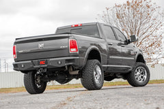 Gray pickup truck with lifted suspension on a road and rear bumper