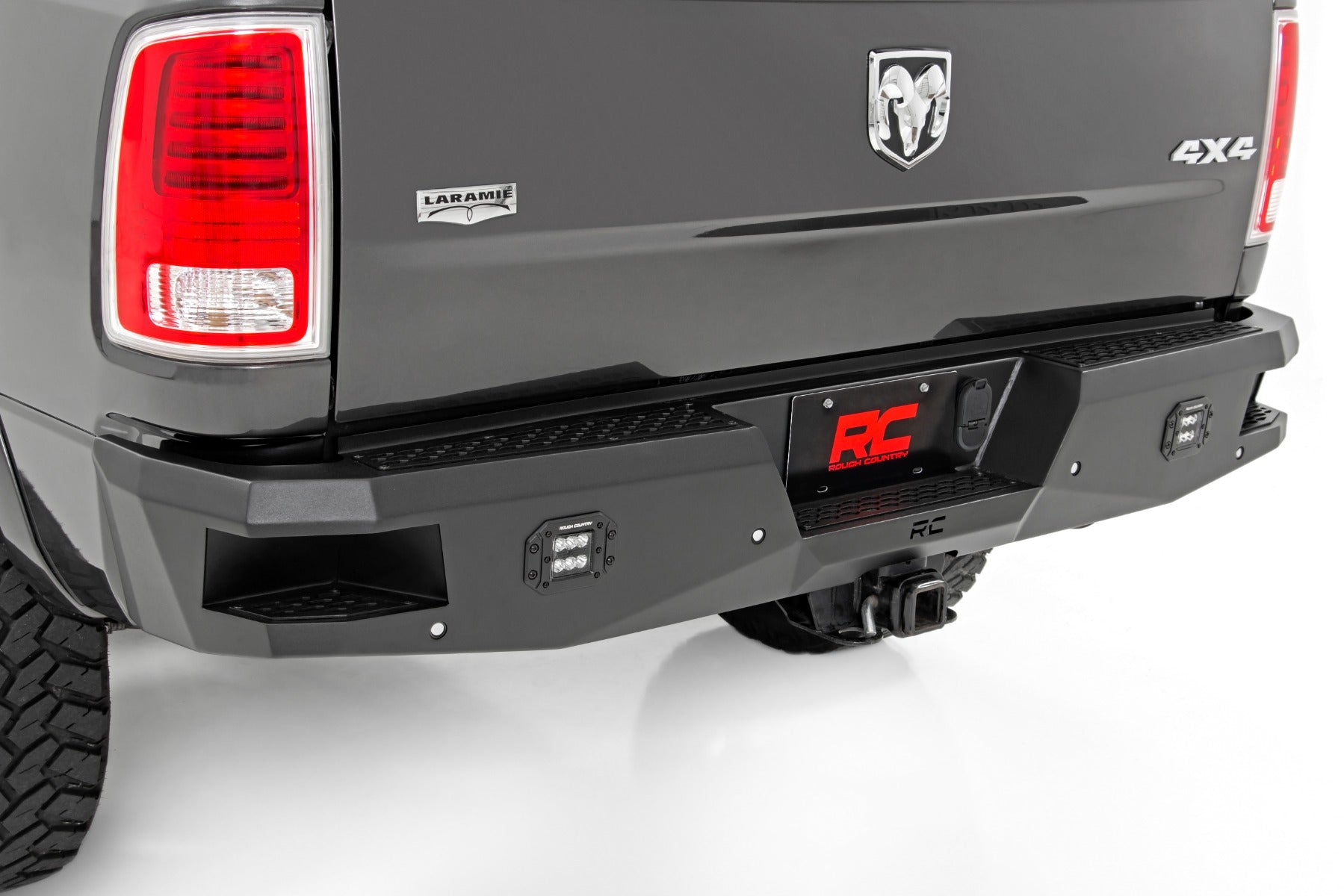 Back view of a black Ram truck with a rough country rear steal bumper.