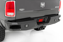 Back view of a black Ram truck with a rough country rear steal bumper.