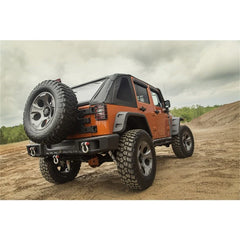 Orange off-road vehicle on a dirt road with a cloudy sky.